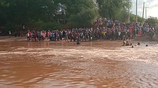 At least 23 die when bus heading to wedding swept into river in Kenya