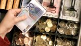 FILE - Euro coins and banknotes are pictured in a shop in Duisburg, Germany, Saturday, Dec. 29, 2001.