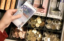 FILE - Euro coins and banknotes are pictured in a shop in Duisburg, Germany, Saturday, Dec. 29, 2001. 