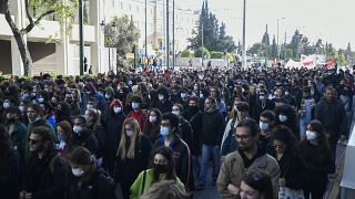 Protesters march during a rally in Athens, Greece, on Monday Dec. 6, 2021.