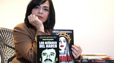 Mexican writer Anabel Hernandez with her book "Emma y las otras señoras del narco", during the Guadalajara International Book Fair in Guadalajara, Mexico, on December 3, 2021.