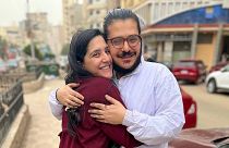 This handout image provided by Egyptian Initiative for Personal Rights (EIPR), shows rights activist Patrick George Zaki hugging his sister after his release, on Dec. 8, 2021.