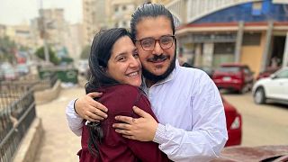 This handout image provided by Egyptian Initiative for Personal Rights (EIPR), shows rights activist Patrick George Zaki hugging his sister after his release, on Dec. 8, 2021.