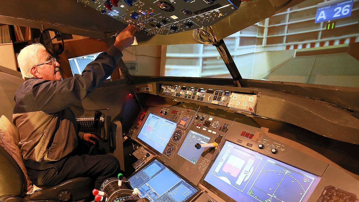 Muhammad Malhas, 76, operates his flight simulator cockpit at his home in Jordan's capital Amman on November 8, 2021.