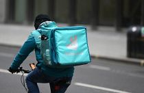 A Deliveroo rider cycles through central London on March 26, 2021.