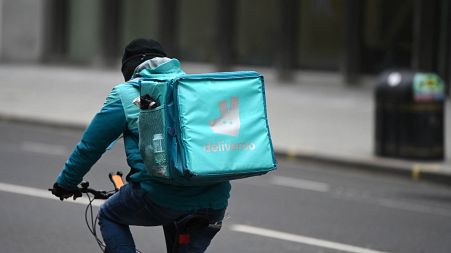 A Deliveroo rider cycles through central London on March 26, 2021. 