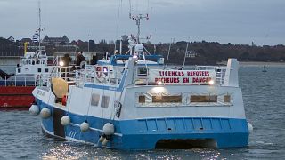 A banner reading "licenses refused. Fishermen in danger" is set on a French fishing boat during a blockage of the entrance to the port of Saint-Malo, France, Nov. 26, 2021.