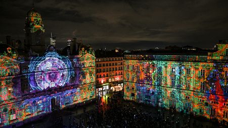People attend the Fêtes des Lumières in Lyon, France, Wednesday, Dec. 8, 2021.