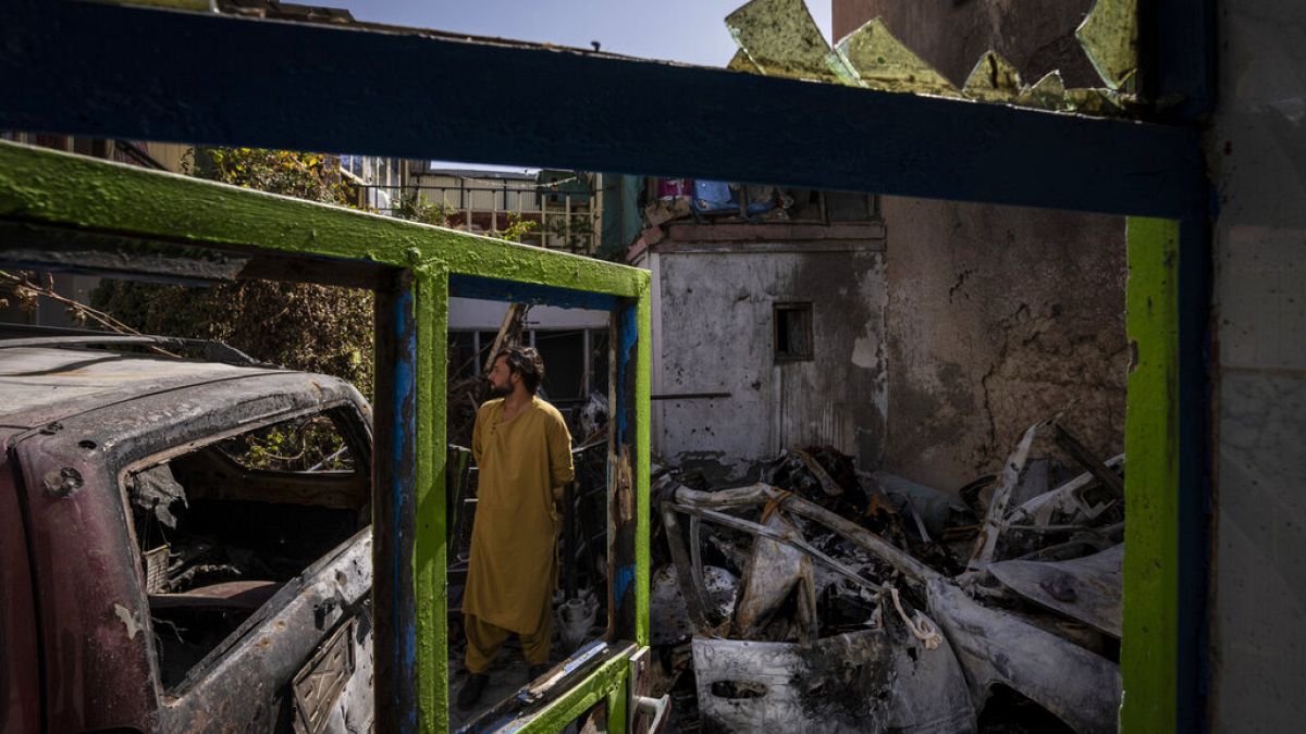 An Afghan citizen inspects the Ahmadi family house in Kabul, where 10 people including seven children were killed by an errant US drone strike in September 2021