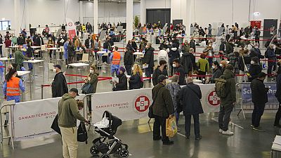 People wait in lines to register for COVID-19 vaccination on the second day of a national lockdown to combat soaring coronavirus infections, in Vienna, Austria, Nov. 23, 2021.