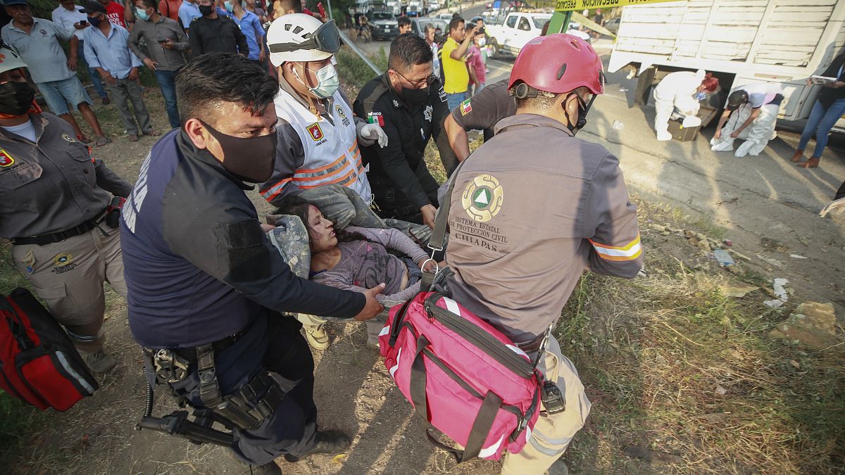 An injured migrant woman is moved by rescue personnel from the site of an accident near Tuxtla Gutierrez, Chiapas state, Mexico, Dec. 9, 2021