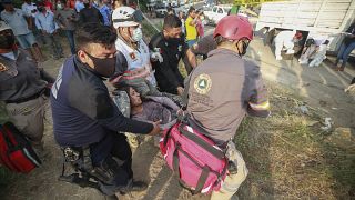 An injured migrant woman is moved by rescue personnel from the site of an accident near Tuxtla Gutierrez, Chiapas state, Mexico, Dec. 9, 2021.