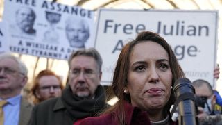 Stella Moris, partner of Julian Assange, speaks to journalists in front of the High Court in London, Friday, Dec. 10, 2021