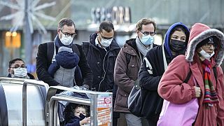 Commuters wearing face masks to protect against COVID-19 ride an escalator at La Defense business district in Paris on Wednesday, December 8