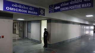 A security guard stands in position outside a ward being prepared for the omicron coronavirus variant at Civil hospital in Ahmedabad, India, Dec. 6, 2021.