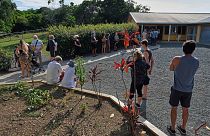 People queue outside a school to vote in a referendum in Noumea, New Caledonia, Sunday December 12, 2021