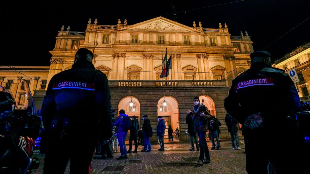 Italian Carabinieri police patrol outside La Scala opera house for the premiere of Verdi's Macbeth in Milan, Italy, Tuesday, Dec. 7, 2021.