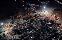 In this aerial photo, a collapsed factory is seen with workers searching for survivors, Saturday, Dec. 11, 2021, in Mayfield, Ky., after tornadoes came through the area the pr