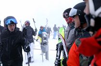 Skiers wait in a lift line on Mount Jahorina, 30 kilometers south of the Bosnian capital of Sarajevo, Saturday, Dec. 11, 2021.