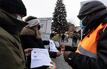 Security personnel check a COVID-19 health pass to access a Christmas market in Strasbourg, eastern France, Dec 3, 2021.