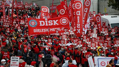 People march during a protest by Turkish trade unions DISK against the government's economy policies in Istanbul, Turkey, Sunday, Dec. 12, 2021.