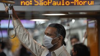 A commuter wears a protective face mask in a subway station, in Sao Paulo, Brazil, Wednesday, Dec. 1, 2021, amid the COVID-19 pandemic.