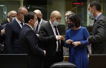 French Foreign Minister, Jean-Yves Le Drian, speaks with German Foreign Minister, Annalena Baerbock, during a meeting of EU foreign ministers