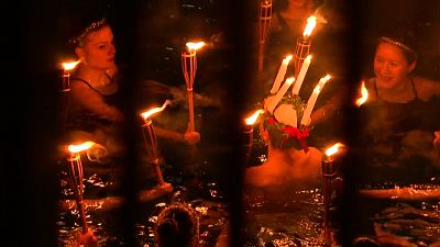 Santa Lucia light celebration performed at a swimming pool in Stockholm