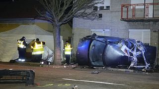 Hungarian police officers work at the scene of a fatal crash, in Morahalom, Hungary, Tuesday, Dec. 14, 2021.