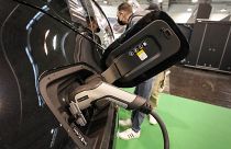 The new full electric car BMW iX is charged at the Motor Show in Essen, Germany, Thursday, Dec. 2, 2021.