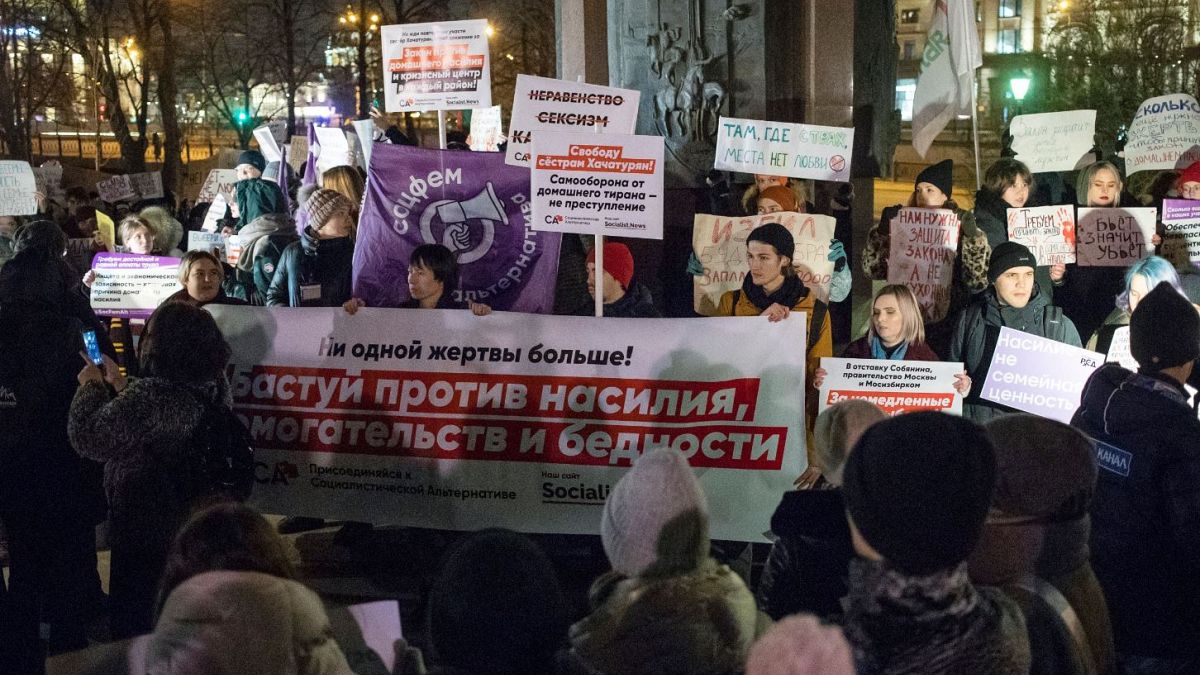 People hold banners against domestic violence during a 2019 rally in downtown Moscow.