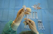 A medical nurse prepares a Moderna vaccination against COVID-19 in a vaccination center set up in a gym of a police barracks in Rome, Dec. 10, 2021.