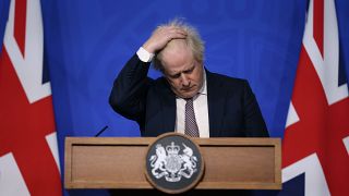 Britain's Prime Minister Boris Johnson gestures as he speaks during a press conference on the coronavirus pandemic in London, Saturday November 27, 2021.