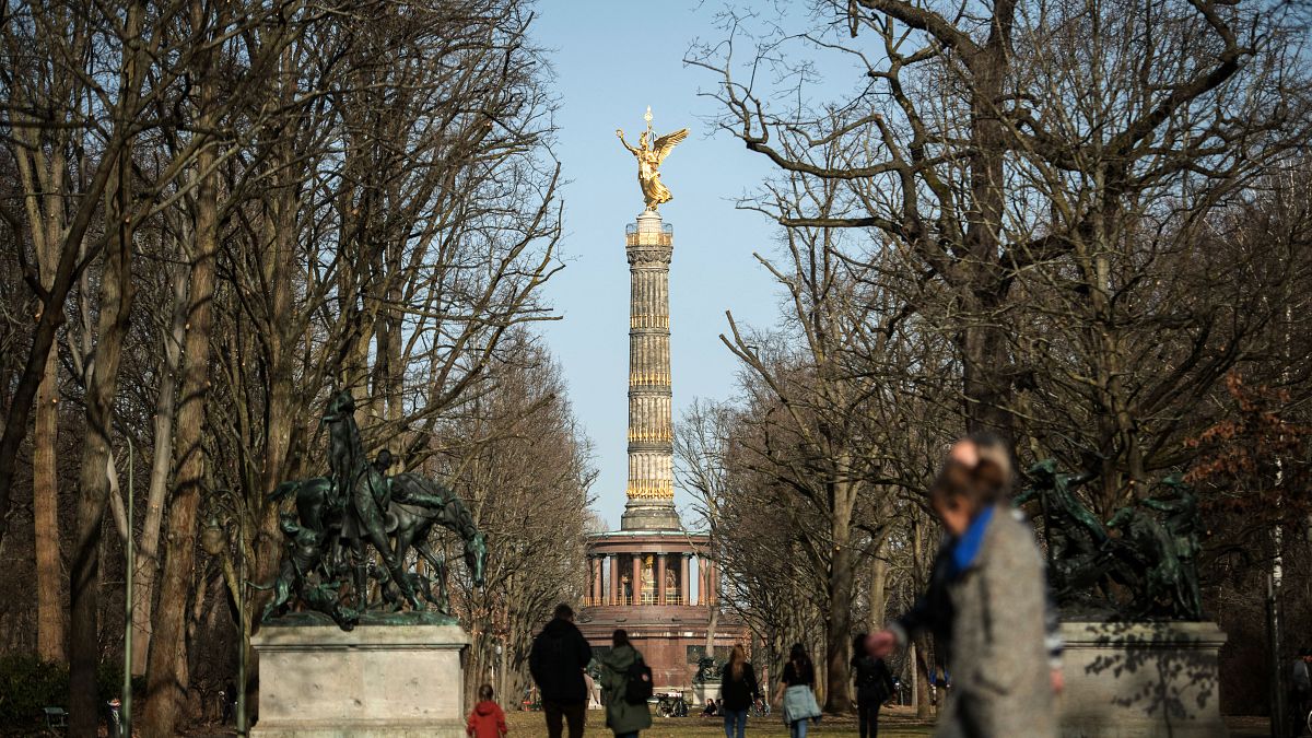 Spaziergänger im Berliner Tiergarten mit Blick auf die Siegessäule, 21.02.2021