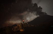 FILE - Ash covers the streets and houses in Las Manchas village as lava flows from the volcano, on the Canary island of La Palma, Spain, Dec. 6 2021.