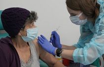 A resident of Warsaw receives a booster shot against COVID-19, in Warsaw, Poland, Tuesday Dec. 7, 2021.