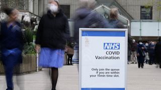 A sign marks the entrance of a vaccination centre at St Thomas' Hospital in London, Wednesday, Dec. 15, 2021.