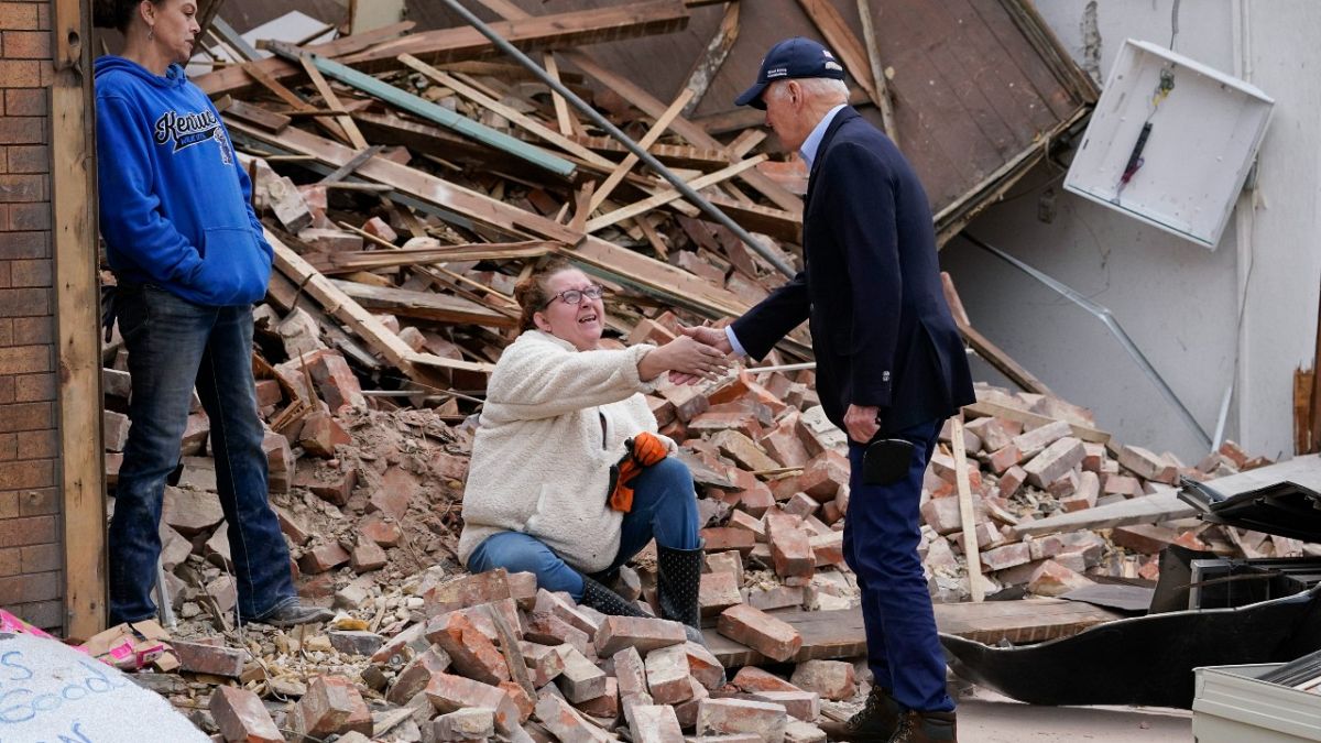 President Joe Biden meets with people as he surveys storm damage from tornadoes and extreme weather in Mayfield, Ky., Wednesday, Dec. 15, 2021. 