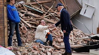 President Joe Biden meets with people as he surveys storm damage from tornadoes and extreme weather in Mayfield, Ky., Wednesday, Dec. 15, 2021. 