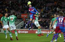 Barcelona's Frenkie de Jong, top, goes for a header with Sergio Canales at a match between Barcelona and Real Betis at Camp Nou 