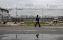 A prison guard inspects inmates at the detention centre of Lipljan.