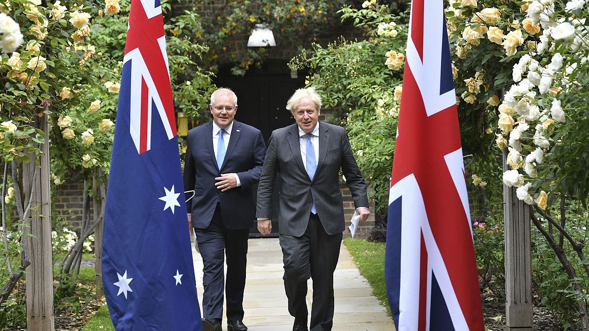 Britain's Prime Minister Boris Johnson, right, walks with Australian Prime Minister Scott Morrison after their meeting, in the garden of 10 Downing Street, June 15, 2021. 