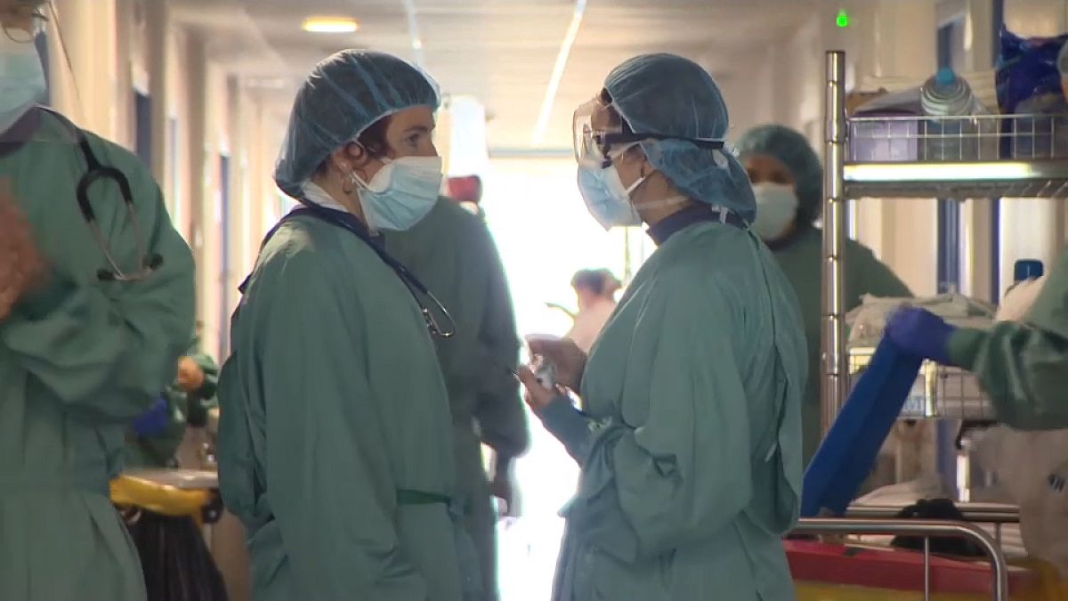Miembros del personal sanitario del Hospital del Mar de Barcelona hablan en los pasillos