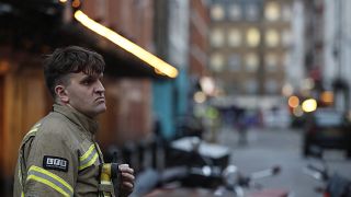 A firefighter stands in a blocked a street in the Soho area of London, Feb. 3, 2020. 