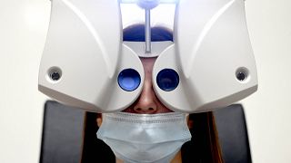 A patient completes a visual exam, conducted by an orthoptist, in a truck dedicated to tele-ophthalmology in Rochefort-sur-Loire on December 9, 2021. 