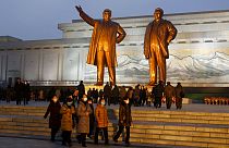 Citizens visit the bronze statues of their late leaders Kim Il Sung, left, and Kim Jong Il on Mansu Hill in Pyongyang