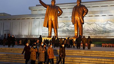 Citizens visit the bronze statues of their late leaders Kim Il Sung, left, and Kim Jong Il on Mansu Hill in Pyongyang