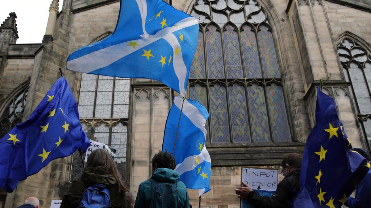 Protesters holding Scottish and European flags gather in front of St Giles' Cathedral facing the Scottish Court of Session in Edinburgh, September 2019