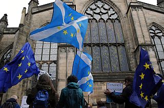 Protesters holding Scottish and European flags gather in front of St Giles' Cathedral facing the Scottish Court of Session in Edinburgh, September 2019