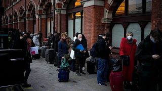 People queue up to travel on trains at London St Pancras International rail station, in London, the Eurostar hub to travel to European countries including France, Dec. 2021.